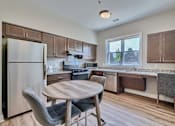 Thumbnail 2 of 32 - A kitchen with a table and chairs.
