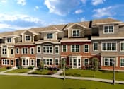 Thumbnail 2 of 30 - A large, multi-story residential building with a brick facade and multiple windows.