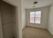Thumbnail 29 of 30 - A small, empty room with a window showing a view of a residential area.