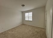 Thumbnail 11 of 30 - A room with a window and a ceiling light.