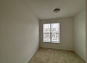 Thumbnail 12 of 30 - A room with a window and a ceiling fan.