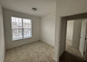 Thumbnail 9 of 30 - A room with a window and a door.