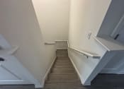 Thumbnail 14 of 30 - A staircase with a white railing and wooden steps.