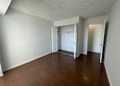 Thumbnail 14 of 26 - A room with white walls and a wooden floor.