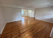 Thumbnail 20 of 29 - A room with wooden flooring and white walls.