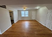Thumbnail 11 of 29 - A room with wooden flooring and a window with blinds.