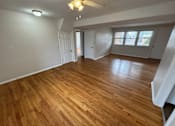 Thumbnail 19 of 29 - A room with wooden flooring and white walls.