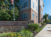 Thumbnail 2 of 17 - The Lodge at Marlton sign in front of a building.
