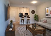 Thumbnail 10 of 54 - a living room and kitchen with a couch and a table