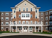 Thumbnail 2 of 54 - a large apartment building with a balcony and a driveway