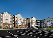 Thumbnail 5 of 54 - an empty parking lot in front of an apartment building