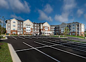 Thumbnail 4 of 54 - an empty parking lot in front of an apartment building