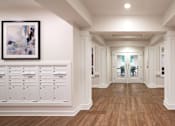 Thumbnail 41 of 54 - a long hallway with white cabinets and white walls and wood floors