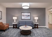 Thumbnail 6 of 54 - a living room with a blue couch and a coffee table