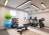 Thumbnail 34 of 54 - a gym with cardio equipment and weights at the preserve apartments