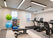 Thumbnail 38 of 54 - a gym with cardio equipment and weights at the preserve apartments
