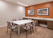 Thumbnail 33 of 54 - a dining area with a table and chairs and a sink