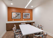 Thumbnail 42 of 54 - a meeting room with a white table and chairs