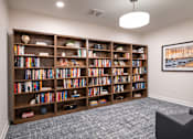 Thumbnail 25 of 54 - room with bookshelves and a couch in front of a window