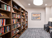 Thumbnail 21 of 54 - room with chairs and bookshelves and a table with a lamp
