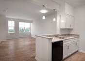 Thumbnail 52 of 54 - an empty kitchen and living room with white cabinets and granite counter tops