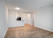 Thumbnail 47 of 54 - an empty living room with white walls and wood flooring