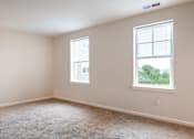 Thumbnail 49 of 54 - an empty bedroom with two windows and carpeting