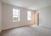 Thumbnail 51 of 54 - an empty living room with two windows and a door