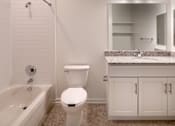Thumbnail 32 of 54 - a bathroom with a toilet and a tub and a sink