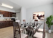 Thumbnail 2 of 37 - A modern kitchen with a dining table set for four.