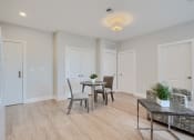 Thumbnail 36 of 43 - a living room and dining room with a table and chairs