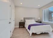 Thumbnail 33 of 43 - a bedroom with a bed and a door to a closet