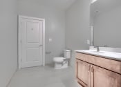 Thumbnail 29 of 43 - an empty bathroom with a toilet and a sink