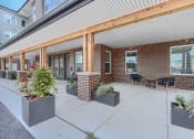 Thumbnail 27 of 43 - the preserve at cardinal woods covered patio in front of a brick building