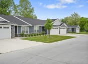 Thumbnail 69 of 74 - a house with a driveway and a lawn in front of it