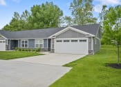 Thumbnail 71 of 74 - the front of a house with a driveway and a garage door