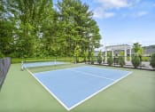 Thumbnail 62 of 74 - a blue and green tennis court with a net on top of it