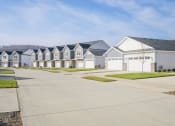 Thumbnail 70 of 74 - a row of white houses with blue roofs on a street