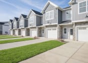 Thumbnail 73 of 74 - a row of houses with white doors and a sidewalk