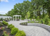 Thumbnail 61 of 74 - a patio with a seating area and a white gazebo