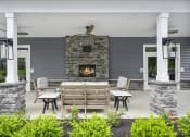 Thumbnail 68 of 74 - the screened porch has a stone fireplace and wooden furniture