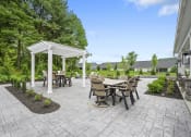 Thumbnail 65 of 74 - a patio with a table and chairs and a white pergola