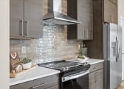 Thumbnail 40 of 74 - a kitchen with a stove and a refrigerator