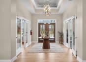 Thumbnail 54 of 74 - a foyer with a table in the middle of it and a chandelier