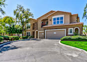Thumbnail 3 of 41 - A large house with a driveway in front.