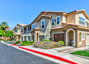 Thumbnail 4 of 41 - A row of houses with a red curb in front.