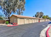 Thumbnail 23 of 41 - A row of garage doors are lined up on a street.