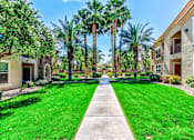 Thumbnail 1 of 41 - A row of houses with a green lawn in front.