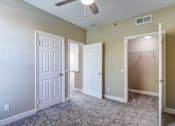 Thumbnail 30 of 41 - A room with a carpeted floor and three doors.