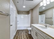 Thumbnail 29 of 41 - A bathroom with a toilet, sink, and mirror.